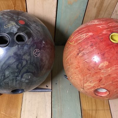 Sale Photo Thumbnail #537: Pair of drilled bowling balls. Includes:
1. Columbia 300 "Freeze" bowling ball in dark swirl finish, made in USA, 
2. Brunswick "Lethal Revolver" bowling ball in orange swirl finish, featuring USBC certification stamp GDC31053.

Condition: Used condition 