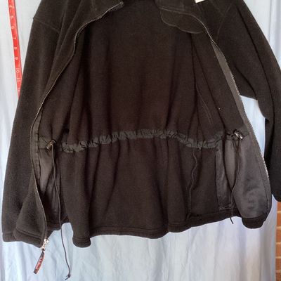 Sale Photo Thumbnail #415: L.L. Bean black full-zip fleece jacket featuring a high collar, hand pockets, and an internal cinch waist toggle drawcord for an adjustable fit. Front measures approximately 28 inches in length. In good pre-owned condition with light signs of wear consist
