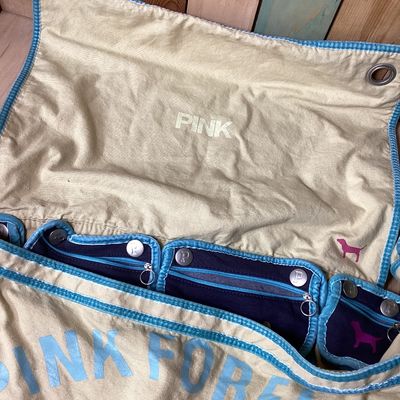 Sale Photo Thumbnail #502: Vintage Victoria's Secret PINK canvas messenger shoulder bag in cream, navy, and teal accents. Features Y2K style embroidered graphics, felt patches ('Live in 86 Pink'), appliqué detailing, multiple interior snap-in zip pouches, and an adjustable shoulde