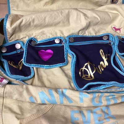 Sale Photo Thumbnail #503: Vintage Victoria's Secret PINK canvas messenger shoulder bag in cream, navy, and teal accents. Features Y2K style embroidered graphics, felt patches ('Live in 86 Pink'), appliqué detailing, multiple interior snap-in zip pouches, and an adjustable shoulde