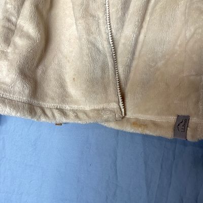 Sale Photo Thumbnail #479: L.L. Bean women's full-zip plush fleece jacket in cream. Made from 100% recycled polyester. Features zipper hand pockets and tan accent zipper pulls. Length measures approximately 27-28 inches. Overall good pre-owned condition with some minor discoloratio