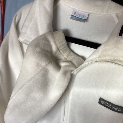 Sale Photo Thumbnail #457: White full-zip soft fleece jacket by Columbia Sportswear Company. Features a high collar, full front zipper, embroidered Columbia patch logo on the chest, and elastic cuffs. Tag size is XXL, made in Vietnam. Measures approximately 26 inches in length from