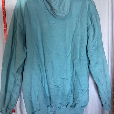 Sale Photo Thumbnail #453: Champion Authentic Athleticwear men's pullover hooded sweatshirt in teal/light blue featuring white script logo printed on front, drawstring hood with gray lining, and front kangaroo pocket. Size XLT (Extra Large Tall). Made in Pakistan. Measures approxim