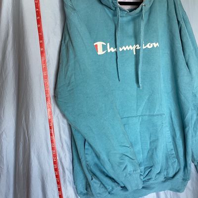 Sale Photo Thumbnail #451: Champion Authentic Athleticwear men's pullover hooded sweatshirt in teal/light blue featuring white script logo printed on front, drawstring hood with gray lining, and front kangaroo pocket. Size XLT (Extra Large Tall). Made in Pakistan. Measures approxim