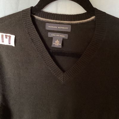 Sale Photo Thumbnail #398: Banana Republic men's long-sleeve V-neck sweater in dark brown/black. Made from 100% extra fine merino wool. Size Small. Features ribbed cuffs and hem. Measures approximately 26 inches in length from shoulder to hem. Good pre-owned condition with light si