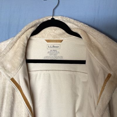 Sale Photo Thumbnail #481: L.L. Bean women's full-zip plush fleece jacket in cream. Made from 100% recycled polyester. Features zipper hand pockets and tan accent zipper pulls. Length measures approximately 27-28 inches. Overall good pre-owned condition with some minor discoloratio