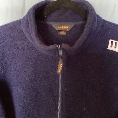 Sale Photo Thumbnail #419: L.L. Bean Outdoors dark navy blue full-zip fleece jacket. Features a high collar, zipper front with L.L. Bean pull tab, and side hand pockets. Made from 100% polyester fleece. Shows light pre-owned wear with minimal pilling and no major flaws visible. Tot