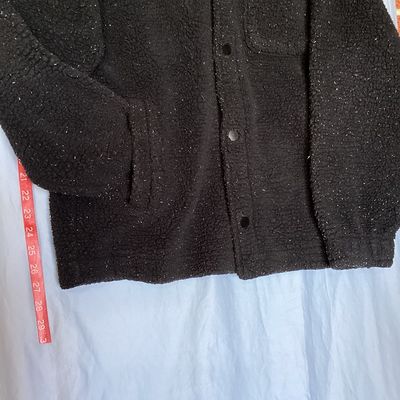 Sale Photo Thumbnail #425: Hollister California fleece sherpa jacket in men's size Large. Features a dark black fabric with white flecked detailing throughout, front snap/button closure, chest patch pocket, side hand pockets, and a collared neckline. Appears to be in good pre-owned