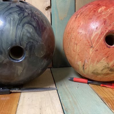 Sale Photo Thumbnail #538: Pair of drilled bowling balls. Includes:
1. Columbia 300 "Freeze" bowling ball in dark swirl finish, made in USA, 
2. Brunswick "Lethal Revolver" bowling ball in orange swirl finish, featuring USBC certification stamp GDC31053.

Condition: Used condition 