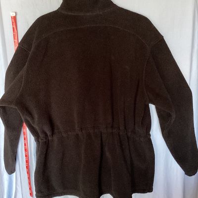 Sale Photo Thumbnail #417: L.L. Bean black full-zip fleece jacket featuring a high collar, hand pockets, and an internal cinch waist toggle drawcord for an adjustable fit. Front measures approximately 28 inches in length. In good pre-owned condition with light signs of wear consist