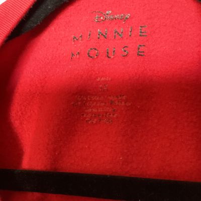 Sale Photo Thumbnail #462: Red crewneck Disney sweatshirt featuring a graphic print of Minnie Mouse in a scarf and skirt with a flower hat. Size tag states 1X. Made of a cotton blend. Shows light wear consistent with pre-owned condition, including some loose threads near the bottom