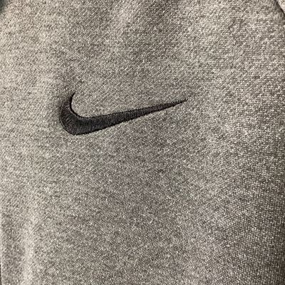 Sale Photo Thumbnail #531: Men's Nike Dri-FIT full zip hoodie in dark gray heather. Features embroidered Nike swoosh logo on the left chest, front hand pockets, and raglan sleeves. Size XL Pre-owned in good condition with light overall wear, no major stains or tears observed.