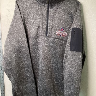 Sale Photo Thumbnail #522: Antigua brand men's size XL heather gray quarter-zip fleece pullover featuring an embroidered Chicago Cubs 2016 World Series Champions emblem on the left chest. Features a zip pocket on the left sleeve and a stand-up collar. In good used condition with li