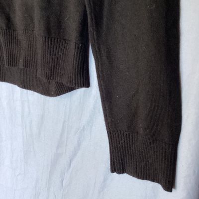 Sale Photo Thumbnail #401: Banana Republic men's long-sleeve V-neck sweater in dark brown/black. Made from 100% extra fine merino wool. Size Small. Features ribbed cuffs and hem. Measures approximately 26 inches in length from shoulder to hem. Good pre-owned condition with light si