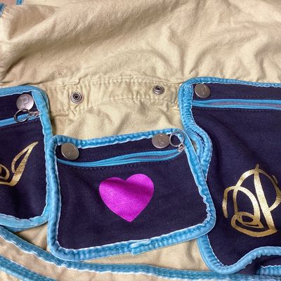 Sale Photo Thumbnail #504: Vintage Victoria's Secret PINK canvas messenger shoulder bag in cream, navy, and teal accents. Features Y2K style embroidered graphics, felt patches ('Live in 86 Pink'), appliqué detailing, multiple interior snap-in zip pouches, and an adjustable shoulde