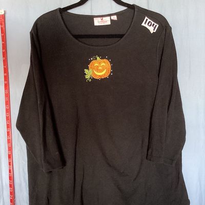 Sale Photo Thumbnail #465: Black long sleeve shirt by Quacker Factory by Jeanne Bice featuring an embroidered and beaded jack-o'-lantern pumpkin design on the chest. Size XL. Good pre-owned condition with light wear consistent with normal use. Length measures approximately 27-28 in
