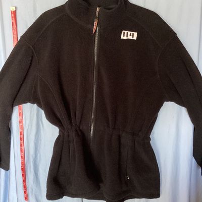 Sale Photo Thumbnail #416: L.L. Bean black full-zip fleece jacket featuring a high collar, hand pockets, and an internal cinch waist toggle drawcord for an adjustable fit. Front measures approximately 28 inches in length. In good pre-owned condition with light signs of wear consist