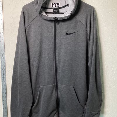 Sale Photo Thumbnail #529: Men's Nike Dri-FIT full zip hoodie in dark gray heather. Features embroidered Nike swoosh logo on the left chest, front hand pockets, and raglan sleeves. Size XL Pre-owned in good condition with light overall wear, no major stains or tears observed.
