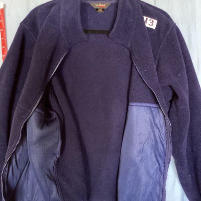 Sale Photo Thumbnail #422: L.L. Bean Outdoors dark navy blue full-zip fleece jacket. Features a high collar, zipper front with L.L. Bean pull tab, and side hand pockets. Made from 100% polyester fleece. Shows light pre-owned wear with minimal pilling and no major flaws visible. Tot