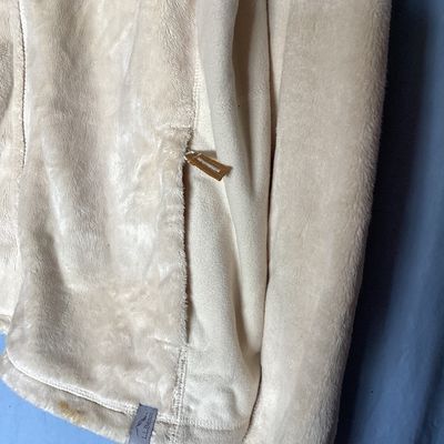 Sale Photo Thumbnail #478: L.L. Bean women's full-zip plush fleece jacket in cream. Made from 100% recycled polyester. Features zipper hand pockets and tan accent zipper pulls. Length measures approximately 27-28 inches. Overall good pre-owned condition with some minor discoloratio