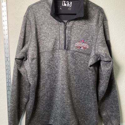 Sale Photo Thumbnail #517: Antigua brand men's size XL heather gray quarter-zip fleece pullover featuring an embroidered Chicago Cubs 2016 World Series Champions emblem on the left chest. Features a zip pocket on the left sleeve and a stand-up collar. In good used condition with li