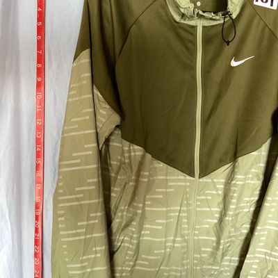 Sale Photo Thumbnail #487: Men's Nike Running Division Therma-Fit hooded full-zip jacket in olive green with patterned light green panels and sleeves. Style code DD6102-386. Features front hand pockets, adjustable hood drawstrings, and reflective Nike swoosh logo on the chest. Size