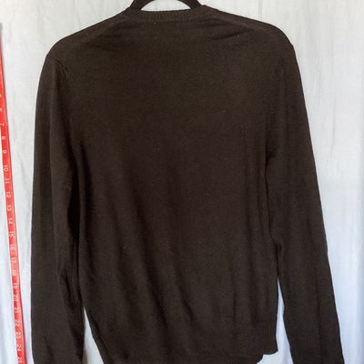 Sale Photo Thumbnail #399: Banana Republic men's long-sleeve V-neck sweater in dark brown/black. Made from 100% extra fine merino wool. Size Small. Features ribbed cuffs and hem. Measures approximately 26 inches in length from shoulder to hem. Good pre-owned condition with light si