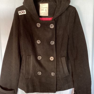 Sale Photo Thumbnail #491: Aeropostale black double-breasted hooded pea coat, women's size XL Features front button closure, side slip pockets, buttoned sleeve cuffs, rear button strap detail, and a bright pink inner. Length measures approximately 26 inches. In good pre-owned condi