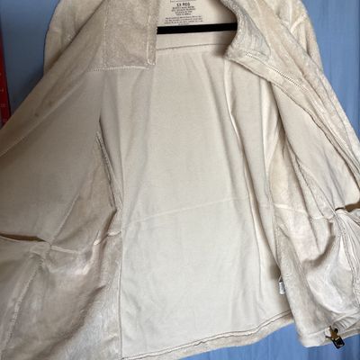 Sale Photo Thumbnail #480: L.L. Bean women's full-zip plush fleece jacket in cream. Made from 100% recycled polyester. Features zipper hand pockets and tan accent zipper pulls. Length measures approximately 27-28 inches. Overall good pre-owned condition with some minor discoloratio