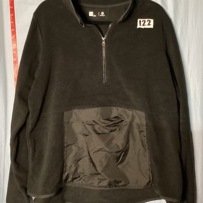 Sale Photo Thumbnail #381: A black fleece quarter-zip pullover jacket by Xersion. Features a front nylon-style kangaroo pocket with a top flap opening, long sleeves, and a mock neck collar. Size XXL. Gently used condition with minor lint/fuzz consistent with normal wear.