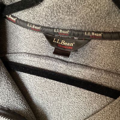 Sale Photo Thumbnail #403: L.L. Bean Outdoors gray fleece jacket featuring a full front zipper, high collar, front pockets, and an adjustable interior cinch drawstring waist. In good pre-owned condition with light signs of wear.