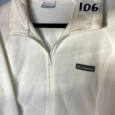 Sale Photo Thumbnail #455: White full-zip soft fleece jacket by Columbia Sportswear Company. Features a high collar, full front zipper, embroidered Columbia patch logo on the chest, and elastic cuffs. Tag size is XXL, made in Vietnam. Measures approximately 26 inches in length from