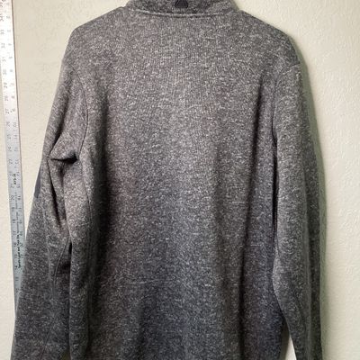 Sale Photo Thumbnail #521: Antigua brand men's size XL heather gray quarter-zip fleece pullover featuring an embroidered Chicago Cubs 2016 World Series Champions emblem on the left chest. Features a zip pocket on the left sleeve and a stand-up collar. In good used condition with li