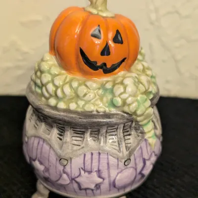cauldron-shaped salt or pepper shaker with a jack-o'-lantern lid from the Fitz and Floyd Kitty Witches Halloween collection