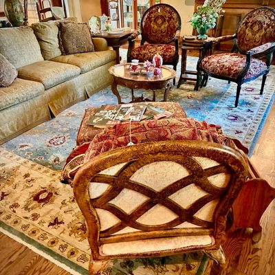 Sale Photo Thumbnail #11: Traditional living room furniture set including a green upholstered sofa, a pair of red and gold patterned armchairs, a carved wood coffee table, and a decorative accent chair with an openwork back.