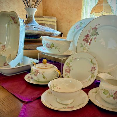Sale Photo Thumbnail #199: Vintage fine china dinnerware set featuring a delicate autumn leaf pattern with gold-trimmed rims, including plates, bowls, a gravy boat, and a lidded sugar bowl.