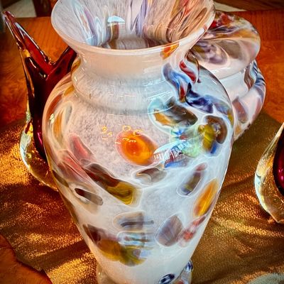 Sale Photo Thumbnail #204: Art glass vase with a flared rim, featuring a mottled white background accented by colorful abstract swirls and spots.