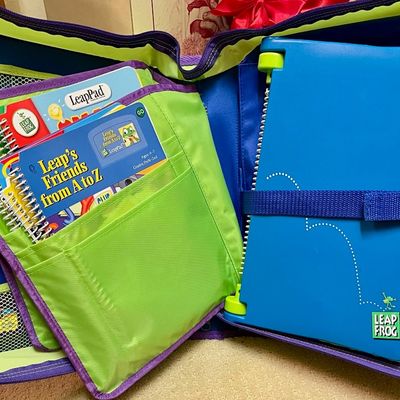 Sale Photo Thumbnail #159: Vintage LeapFrog LeapPad learning system with interactive books, housed in a green and blue zippered carrying case.