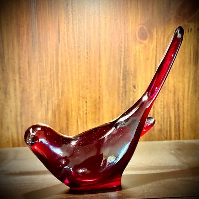 Sale Photo Thumbnail #222: Mid-century ruby red art glass bird figurine, featuring a stylized form with an elongated tail.