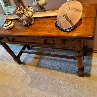 Sale Photo Thumbnail #223: Rustic wooden console table with turned legs and a single drawer, displaying various vintage glassware and decorative items.