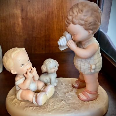 Sale Photo Thumbnail #149: Vintage bisque porcelain figurine depicting a child taking a photo of a baby and a puppy, in the style of Goebel Hummel or Precious Moments.