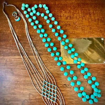 Sale Photo Thumbnail #78: Vintage jewelry collection featuring a long double-strand turquoise-colored bead necklace and a multi-strand liquid silver necklace with a woven turquoise bead accent.