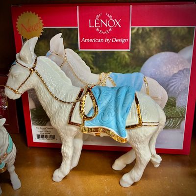Sale Photo Thumbnail #129: Lenox First Blessing Nativity donkey figurine, crafted in ivory porcelain with gold accents and a blue blanket, shown with its original box.
