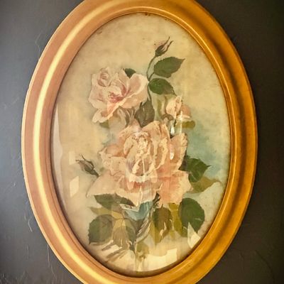 Sale Photo Thumbnail #194: Vintage oval framed floral print featuring pink roses, housed in a gold-finished wooden frame under glass.
