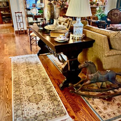 Sale Photo Thumbnail #20: Traditional dark wood sofa table styled with a crystal table lamp, decorative boxes, and a vintage wooden rocking horse on the floor nearby.