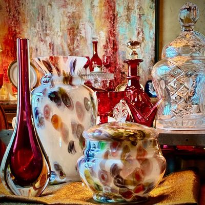 Sale Photo Thumbnail #28: Collection of art glass and crystal, featuring a Murano-style sommerso bud vase, a multi-colored end-of-day glass vase and matching lidded jar, and a cut crystal biscuit barrel.