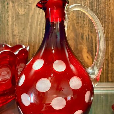 Sale Photo Thumbnail #136: Vintage ruby red cut-to-clear glass decanter with a coin dot pattern, clear glass handle, and ball stopper.