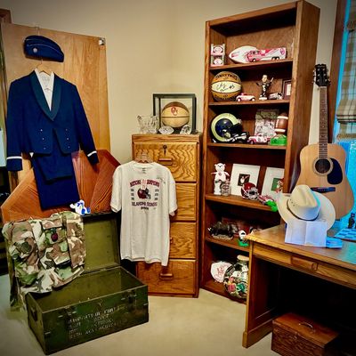 Sale Photo Thumbnail #206: Collection of military uniforms, sports memorabilia including Oklahoma Sooners items, oak office furniture, and an acoustic guitar.