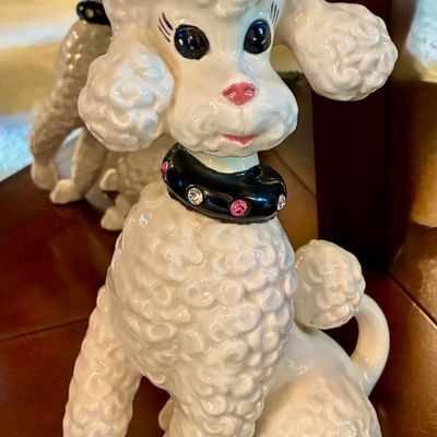 Sale Photo Thumbnail #187: Vintage mid-century ceramic white poodle figurine featuring a black collar adorned with pink and clear rhinestones.