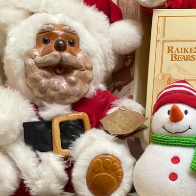 Sale Photo Thumbnail #181: Vintage Raikes Bears Santa Claus plush teddy bear featuring a carved wooden face and paw pads, shown alongside a small plush snowman.